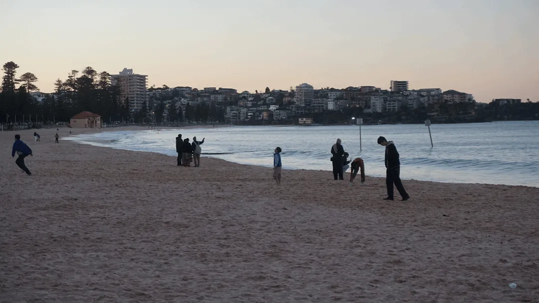 Manly Beach with people while the sun is setting